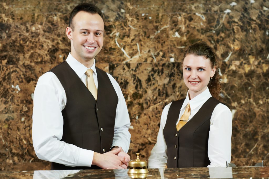 Hotel worker on reception - HospitalityLawyer.com®