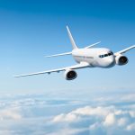 White passenger aircraft flying over clouds - HospitalityLawyer.com®