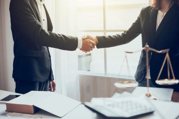 Businessman and lawyer shaking hands.