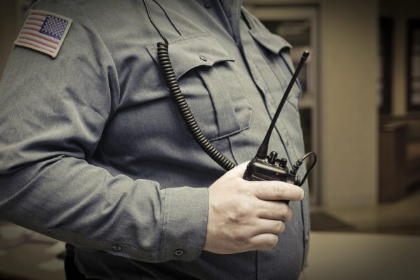Security guard with walkie talkie in hand