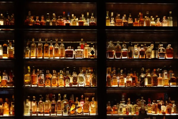 Stylish wall full of spirit bottles in a bar