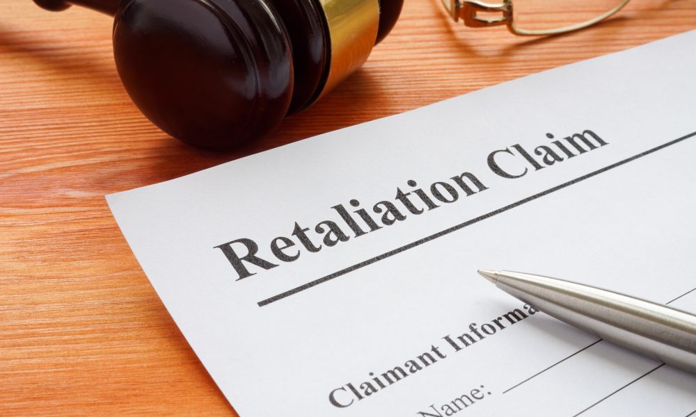 Retaliation claim lying on the desk with gavel.