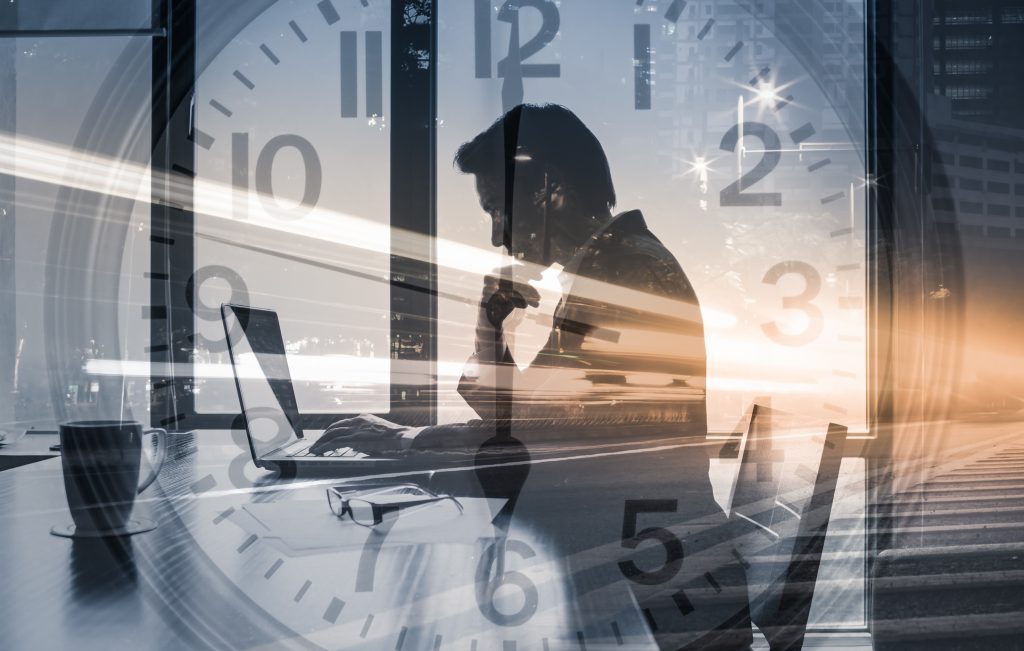 Businessman working hard in his office - HospitalityLawyer.com® Work deadline, business success, and strategy concept. Double exposure