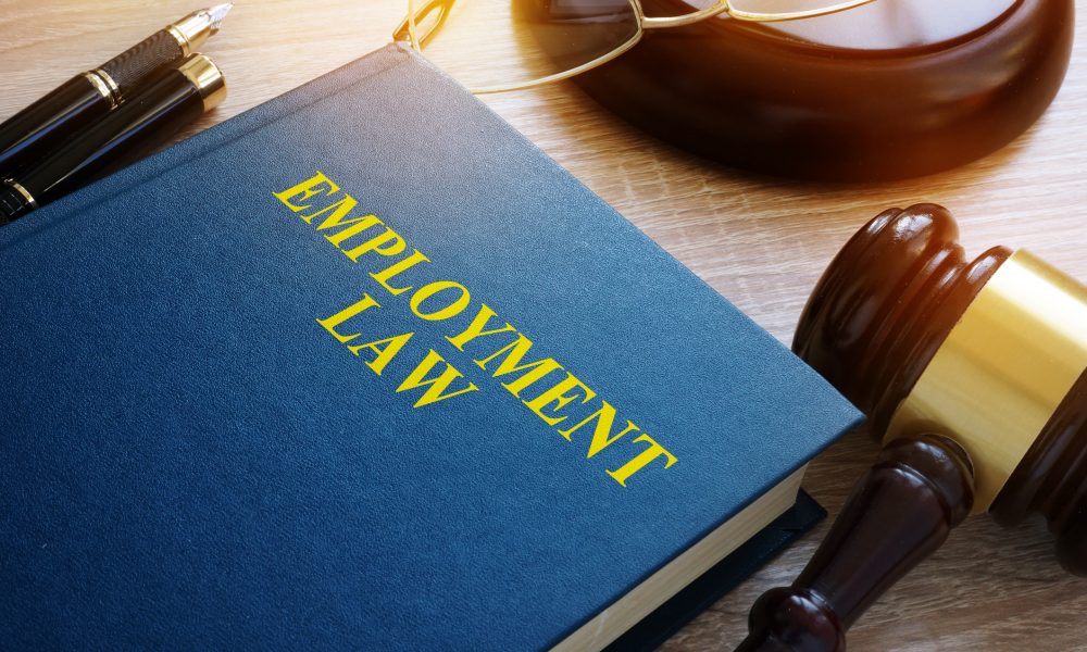 Employment law concept. Book and gavel on a desk.