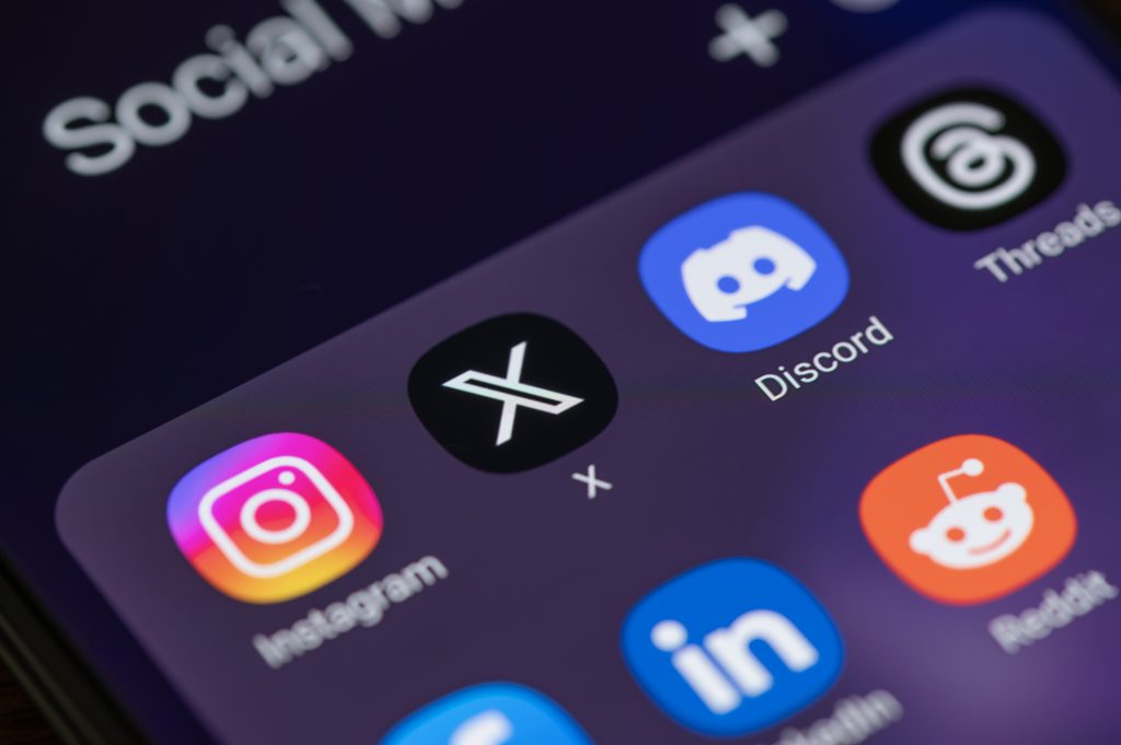 Social media applications X, instagram, LinkedIn, discord, reddit, Threads, Facebook on smart phone screen.
