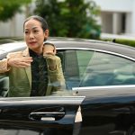 Asian Senior businesswoman executive travelling by a personal car - HospitalityLawyer.com® Asian Senior businesswoman executive travelling by a personal car.