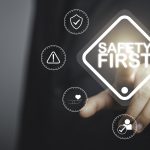Work safety concept Businessman touching Safety first text Safety first sign on virtual screen Hazards protections regulations and insurance Zero accidents Protection dangerous - HospitalityLawyer.com®