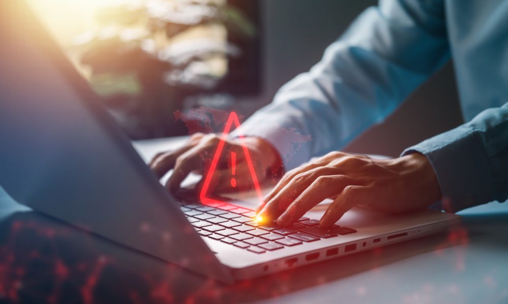 System hacked warning alert on notebook (Laptop). Cyber attack on computer network, Virus, Spyware, Malware or Malicious software. Cyber security and cybercrime. Compromised information internet.