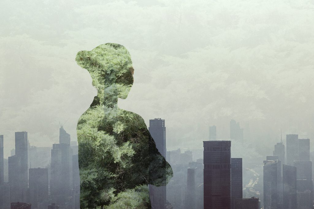 adult woman person standing with ideas in contemplation and absence in smog urban city reflection with nature trees multi-layered effect in silhouette shadow rear view waist up composite image women - HospitalityLawyer.com®