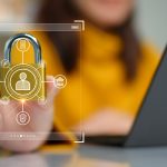 Cybersecurity concept A person is holding onto a padlock containing a data privacy protection system from digital threats Protect hardware software and applications connect to work on the Internet - HospitalityLawyer.com®