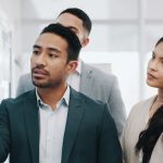 Business people coaching and presentation in team brainstorming strategy or schedule planning at office Businessman or mentor talking to group in staff training project plan or tasks at workplace - HospitalityLawyer.com®