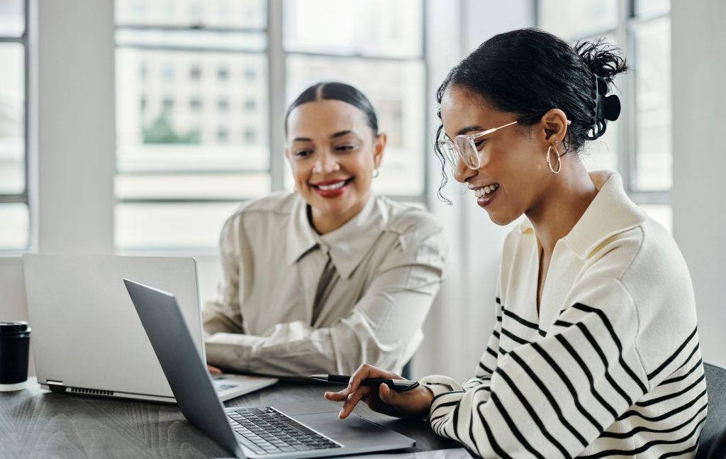 Business women laptop and and happy team in office for web design collaboration and training Planning digital marketing and coaching by woman leader menor help explain and support creative goal - HospitalityLawyer.com®