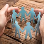 Businessmans Hands Covering Paper Team On Table - HospitalityLawyer.com®