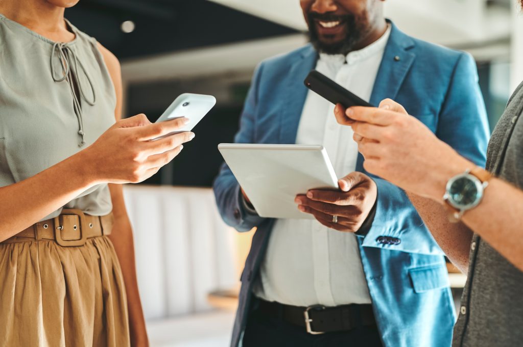 Diversity in working team using internet on phones and digital tablet for teamwork growth in the office Professional staff work with 5g technology to match work schedule online the company website - HospitalityLawyer.com®