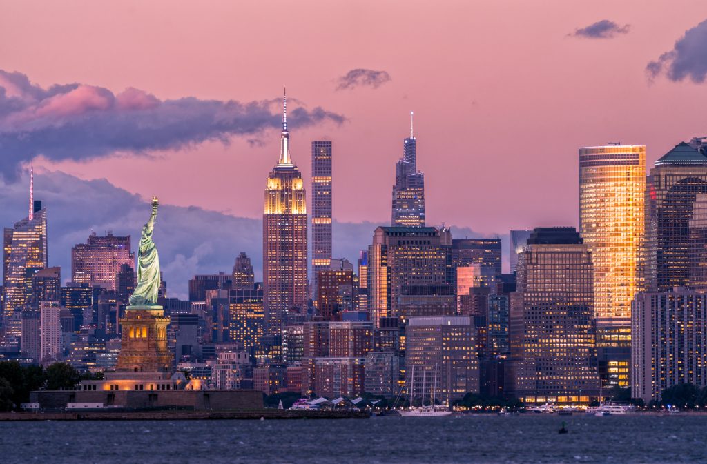 New York City Skyline and Statue of Liberty at Dusk - HospitalityLawyer.com®