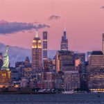 New York City Skyline and Statue of Liberty at Dusk - HospitalityLawyer.com®
