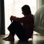 Woman depression in bedroom - HospitalityLawyer.com®