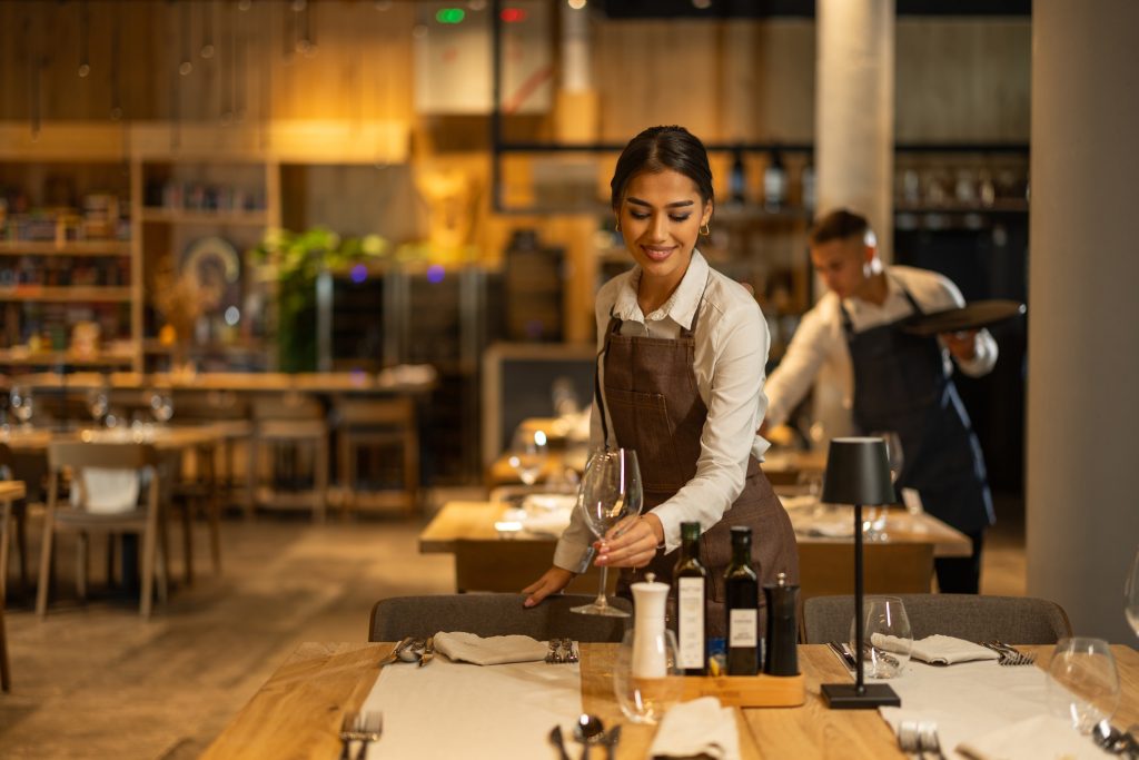 Beautiful waitress working - HospitalityLawyer.com®