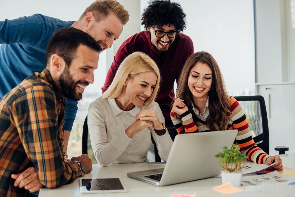 Young coworkers using laptop - HospitalityLawyer.com®