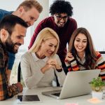 Young coworkers using laptop - HospitalityLawyer.com®