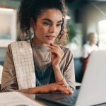 Business owner thinking and woman in restaurant laptop and problem solving for inventory Person employee or barista in coffee shop tech or online reading for review decision or report for sales - HospitalityLawyer.com®
