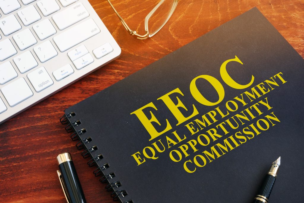 Equal Employment Opportunity Commission EEOC on a desk - HospitalityLawyer.com®