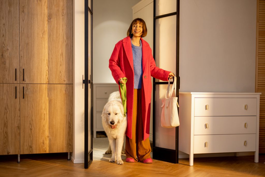 Woman comes home with her dog from a walk - HospitalityLawyer.com®
