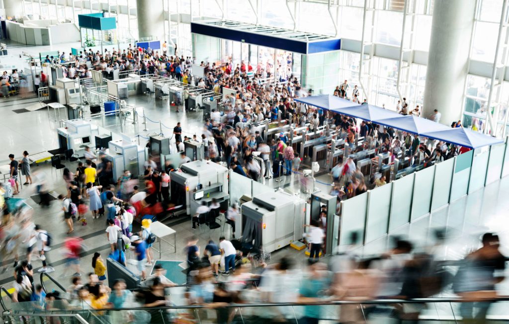 Crowd of people on railroad station lobby - HospitalityLawyer.com®
